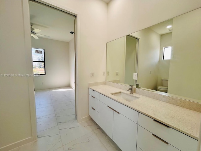 bathroom with vanity, ceiling fan, and toilet