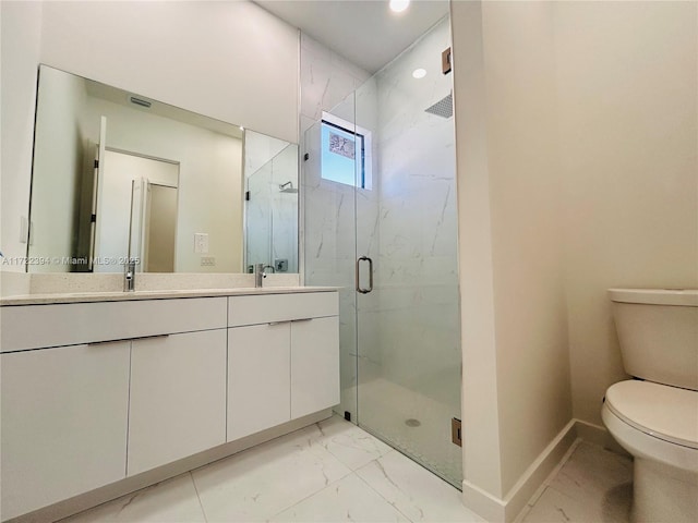 bathroom with vanity, toilet, and a shower with shower door