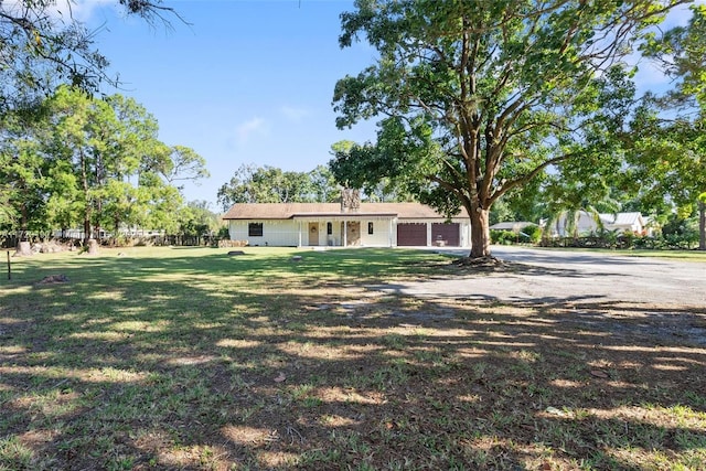 view of front of house with a front yard and a garage