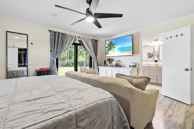 bedroom with access to exterior, ensuite bath, ceiling fan, and light wood-type flooring