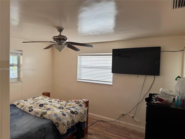 bedroom with ceiling fan and wood-type flooring