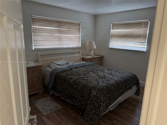 bedroom with dark wood-type flooring