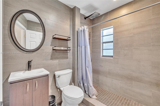 bathroom with curtained shower, vanity, and toilet