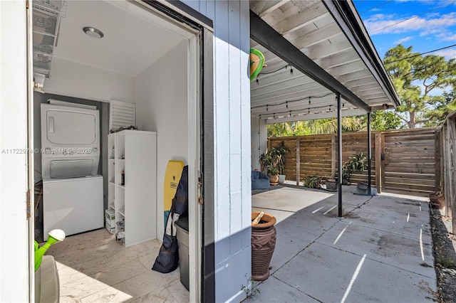 view of patio with stacked washer / drying machine