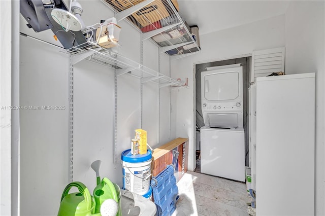 laundry area with stacked washer and dryer