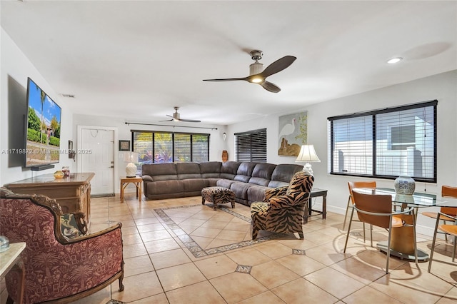 tiled living room featuring ceiling fan and plenty of natural light