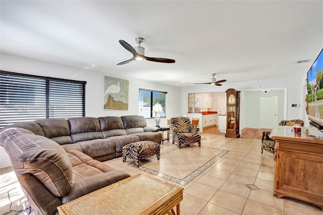 tiled living room with ceiling fan