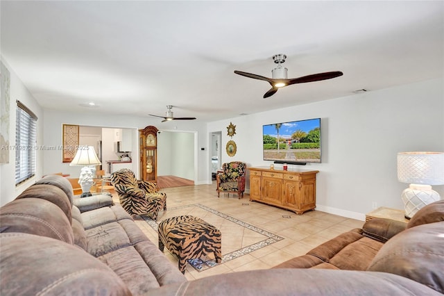 tiled living room with ceiling fan