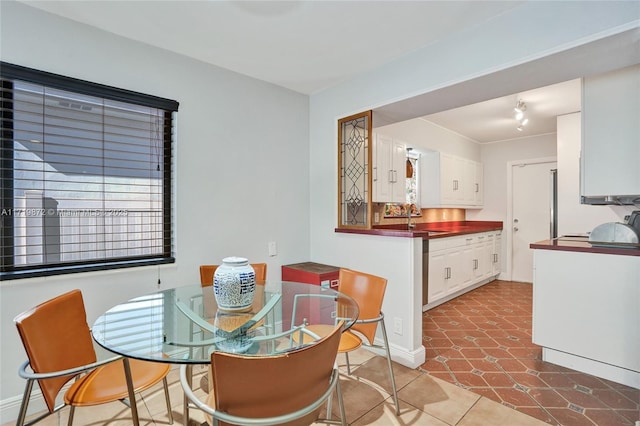 tiled dining room featuring sink