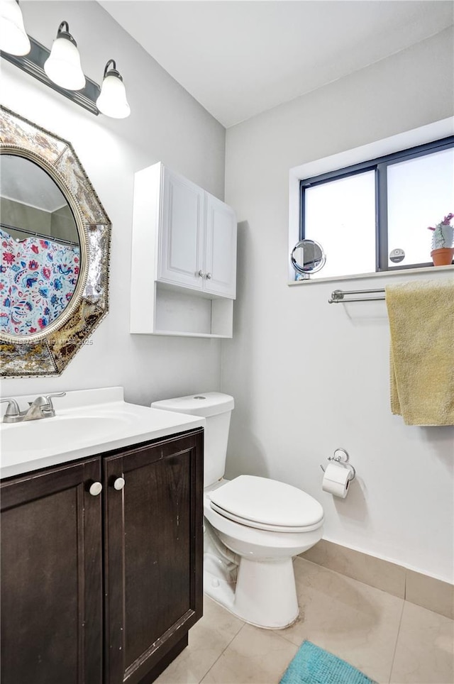 bathroom featuring toilet, tile patterned flooring, and vanity