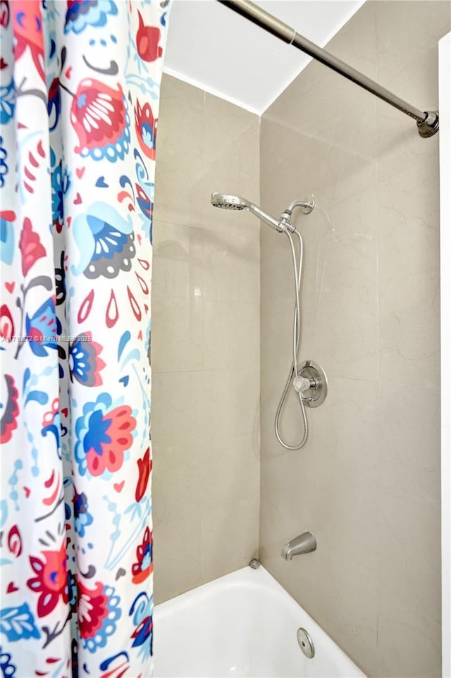 bathroom featuring shower / bathtub combination with curtain