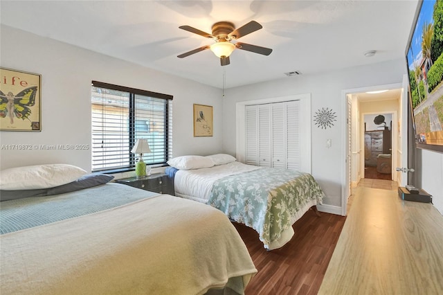 bedroom featuring ceiling fan, hardwood / wood-style flooring, and a closet