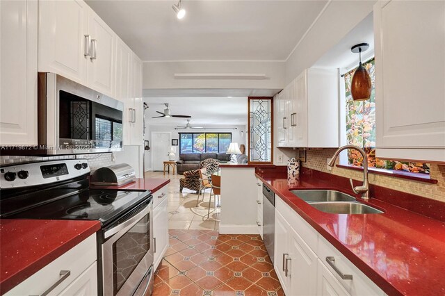 1911 Dewey St, Hollywood, FL 33020 - kitchen with stainless steel appliances, a sink, dark countertops, and tasteful backsplash