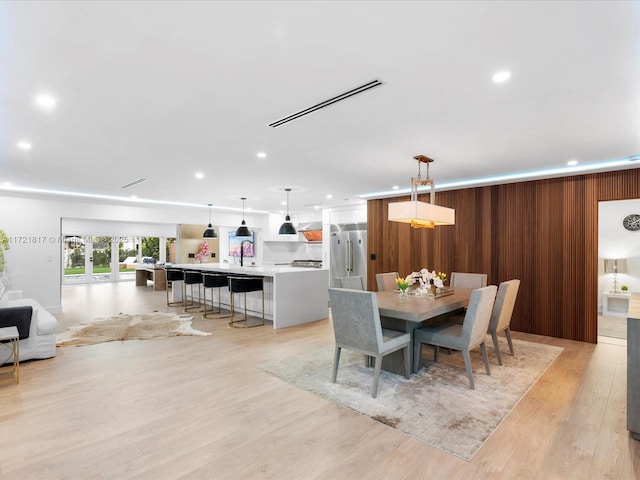 dining room featuring sink and light hardwood / wood-style flooring