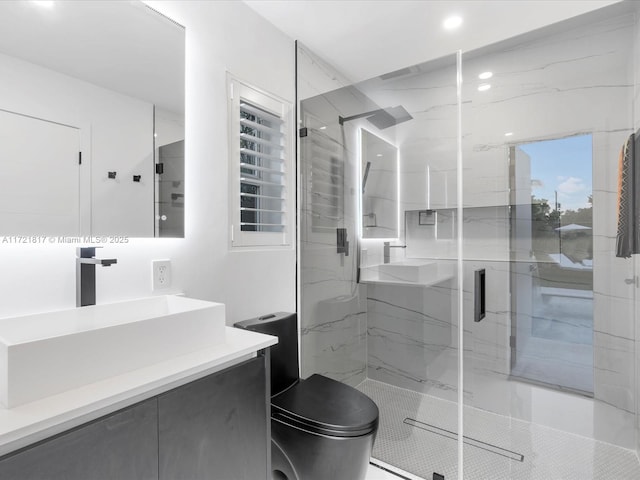 bathroom featuring vanity, toilet, and a shower with shower door