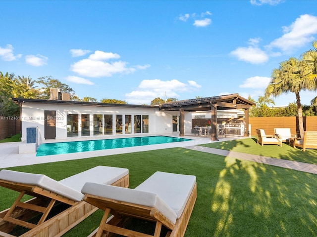 view of pool featuring a patio and a lawn