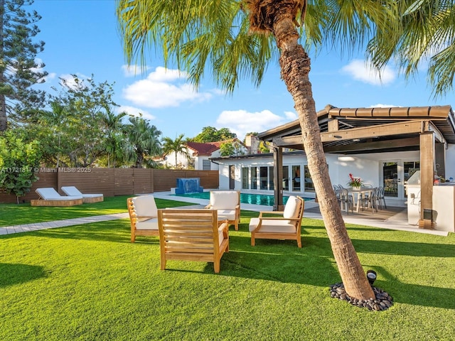 rear view of house featuring a patio area, a fenced in pool, and a yard