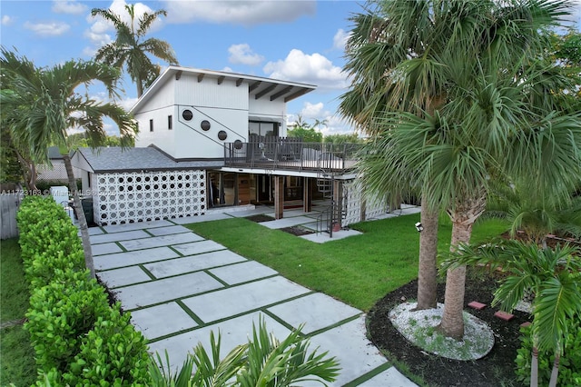 view of front of home with a front lawn and a patio area