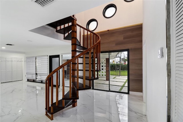 foyer featuring wooden walls