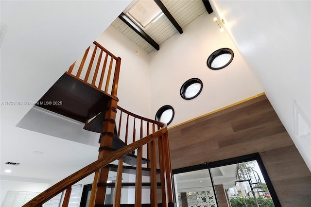 stairs featuring vaulted ceiling with beams and wooden ceiling