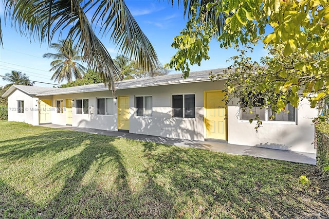 back of property featuring a lawn