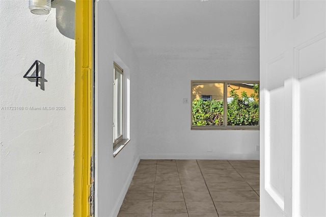 corridor featuring dark tile patterned flooring