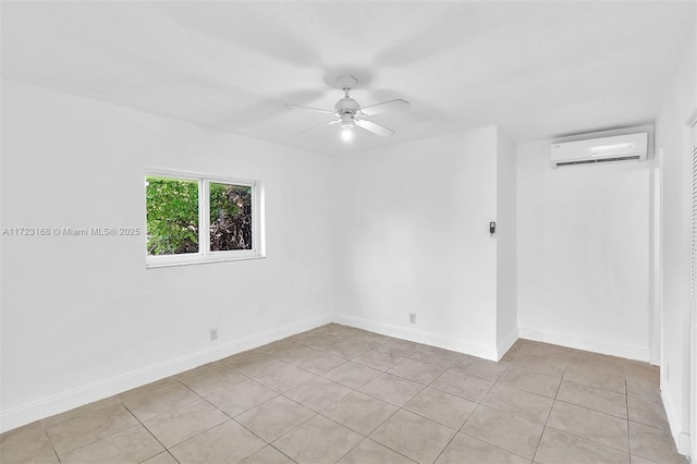 spare room with a wall unit AC, ceiling fan, and light tile patterned floors