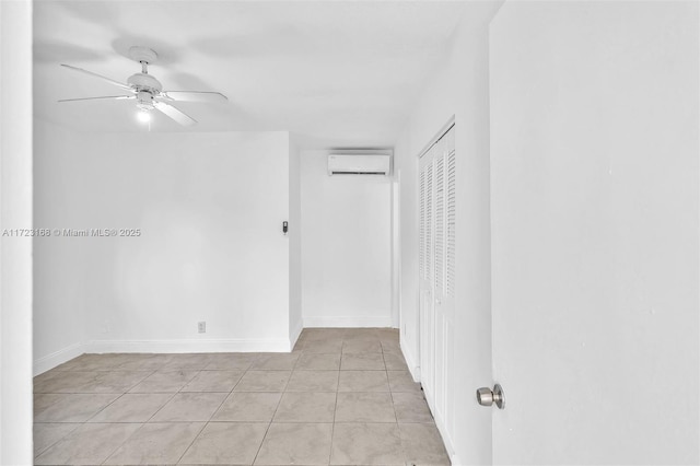 tiled empty room with ceiling fan and an AC wall unit