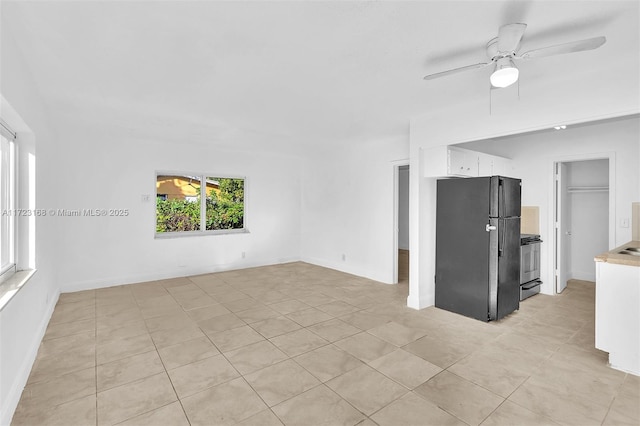 unfurnished living room with ceiling fan and light tile patterned floors