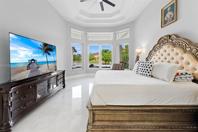 bedroom featuring ceiling fan, ornamental molding, and a high ceiling