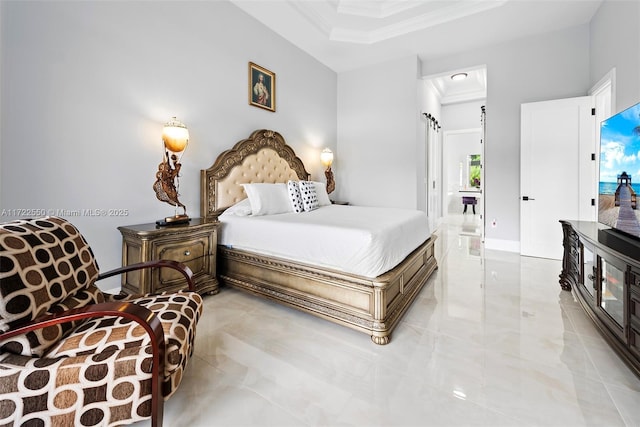 bedroom featuring ensuite bath, a high ceiling, and ornamental molding