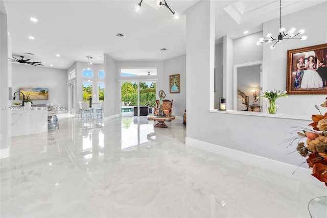 interior space featuring french doors, a towering ceiling, and a chandelier