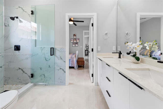 bathroom with vanity, ceiling fan, toilet, and walk in shower