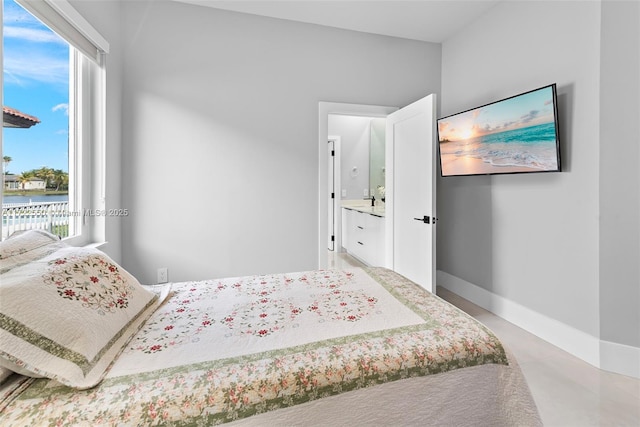 bedroom with a water view and multiple windows