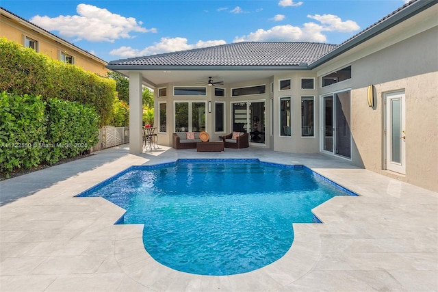 view of pool with outdoor lounge area, ceiling fan, and a patio