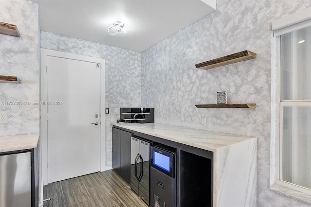 kitchen featuring wine cooler and refrigerator