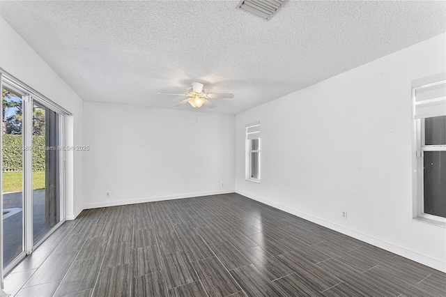 spare room featuring a textured ceiling and ceiling fan