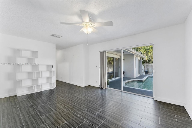 unfurnished room with a textured ceiling and ceiling fan