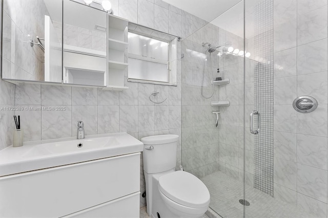 bathroom featuring vanity, decorative backsplash, toilet, tile walls, and a shower with shower door