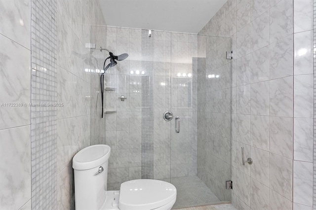 bathroom with toilet, an enclosed shower, and tile walls