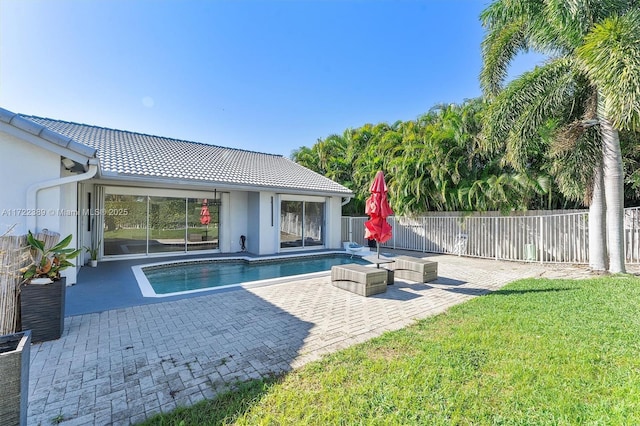 view of swimming pool featuring a lawn and a patio