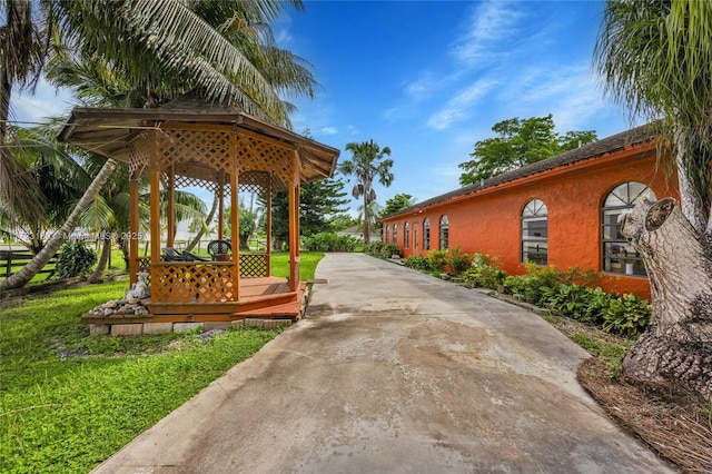 view of property's community featuring a wooden deck and a lawn