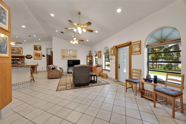 living room featuring ceiling fan, plenty of natural light, and vaulted ceiling