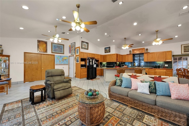 living room with light tile patterned flooring and high vaulted ceiling