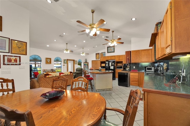 dining space featuring sink, high vaulted ceiling, ceiling fan, and light tile patterned flooring