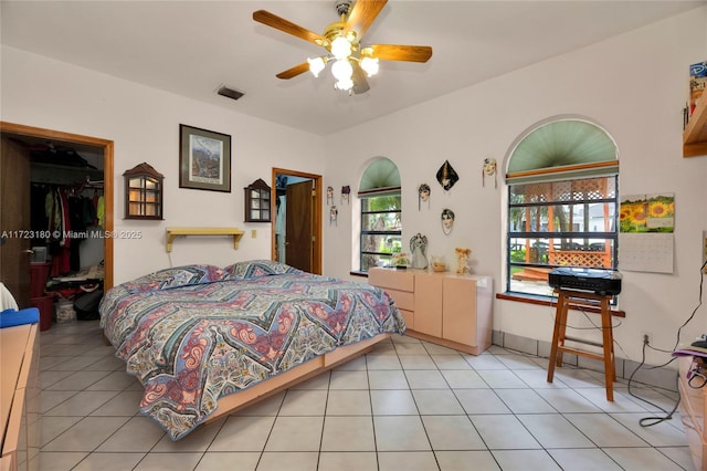 tiled bedroom featuring a closet and ceiling fan