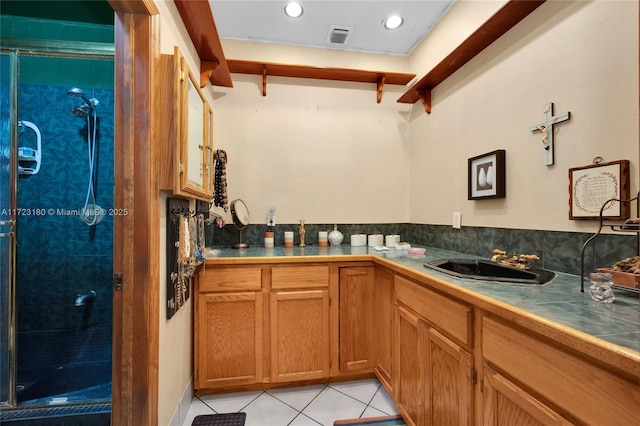 kitchen featuring tile countertops, light tile patterned floors, sink, and beamed ceiling