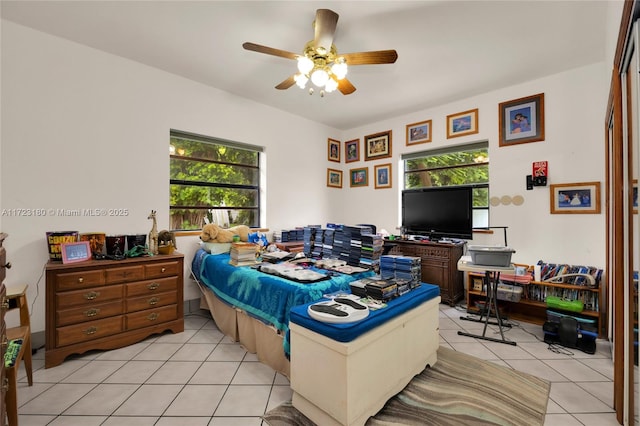 bedroom with ceiling fan and light tile patterned floors