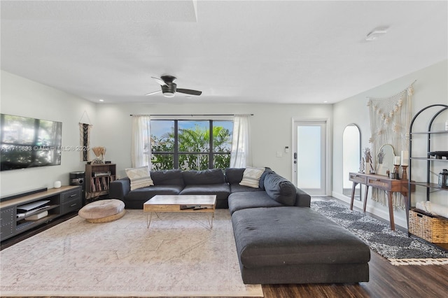 living room with hardwood / wood-style floors and ceiling fan