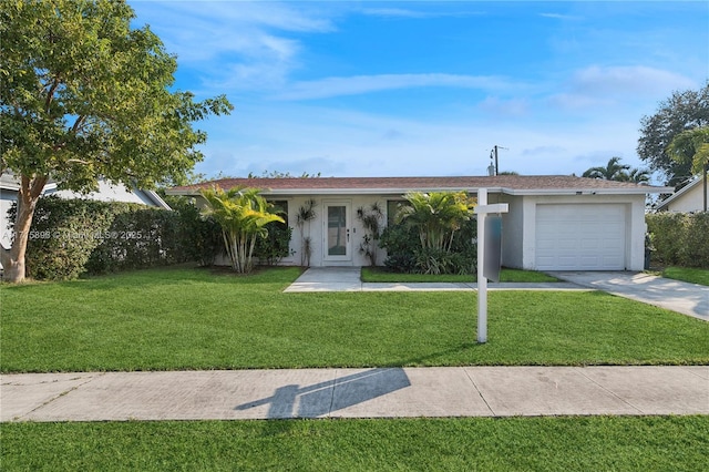 single story home featuring a garage and a front yard